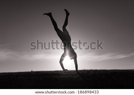 Silhouette of young man doing gymnastics.