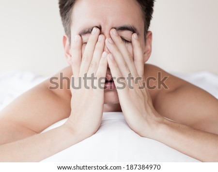 Man in bed suffering insomnia and sleep disorder. Lack of sleep.