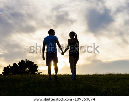 Silhouette of happy couple outdoors. Couple in love.