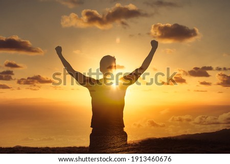 Strong powerful man flexing his arms up to the sky. Mental and physical strength concept.