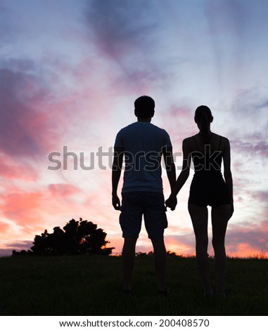 Silhouette of romantic couple enjoying sunset, Hawaii, USA