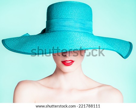 Woman wearing hat. Fashion studio portrait