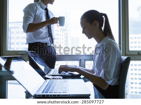 Male and female office workers.