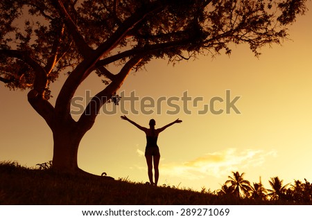 Silhouette of woman with hands raised up. Enjoyment, freedom, religion concept