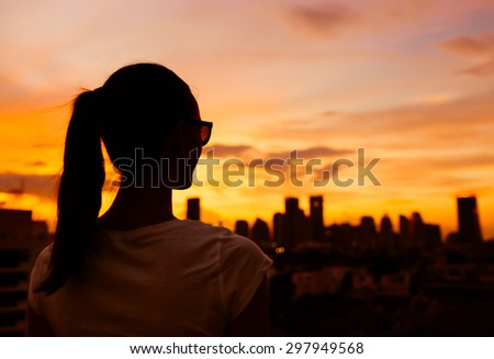 Woman enjoying the sun set in the city.
