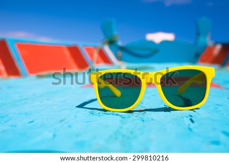 Pair of sunglasses on a boat deck.