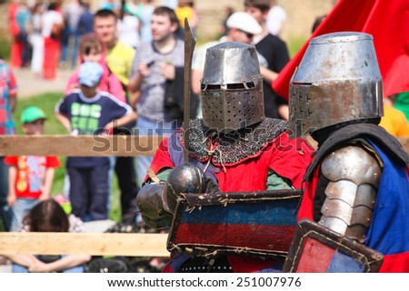 Two armored knights prepare to fight on a medieval festival in Akkerman fortress - May 2, 2013, Belgorod-Dnestrovsky, Ukraine