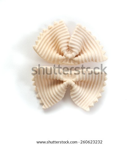 Italian bows farfalle pasta with salmon from durum wheat on a white background, top view