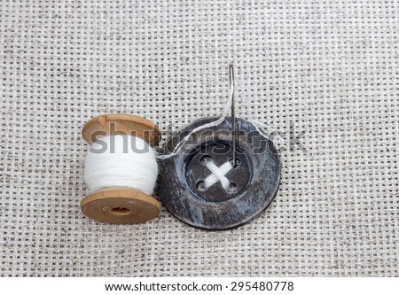 wood spool with white thread, needle and sewn stitch large wood sewing button scrapbooking, arts and crafts