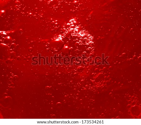 A beautiful background. Red juice mixed and formed bubbles