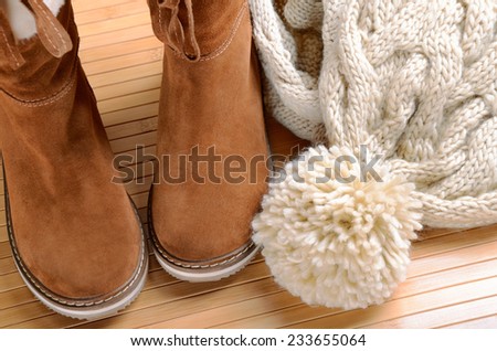 winter boots, hat and scarf on the floor horizontal