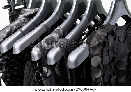 black women\'s clothing hanging on the black plastic hanger horizontal frame