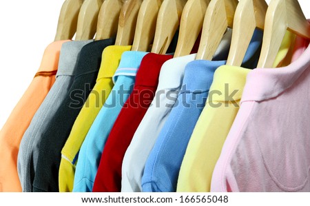 Colorful polo shirts for men on hanger isolated over white