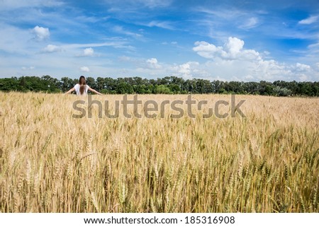 Young women walking through a Golden weed  field. Argentina countryside. South America.