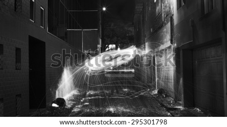 Sparks Flying off Burning Steel Wool in Alleyway at Night Black & White