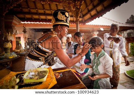 BALI, INDONESIA - MARCH 28: Unidentified child during the ceremonies of Oton - is the first ceremony for baby\'s on which the infant is allowed to touch the ground on March 28, 2012 on Bali, Indonesia.