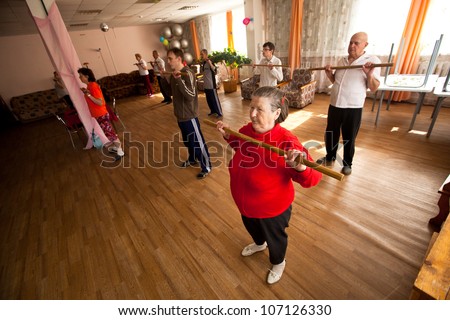 PODPOROZHYE, RUSSIA - JULY 5: Day of Health in Center of social services for pensioners and the disabled Otrada (gymnastics with sticks for eldery and disabled), July 5, 2012 in Podporozhye, Russia.