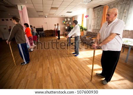 PODPOROZHYE, RUSSIA - JULY 5: Day of Health in Center of social services for pensioners and the disabled Otrada (gymnastics with sticks for eldery and disabled), July 5, 2012 in Podporozhye, Russia.