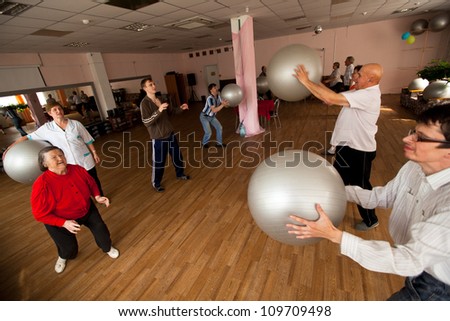 PODPOROZHYE, RUSSIA - JULY 5: Day of Health in Center of social services for pensioners and disabled Otrada (gymnastics with ball for eldery and disabled), July 5, 2012 in Podporozhye, Russia.