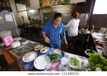 CHANG, THAILAND - JANUARY 23:  Unknown vendors prepare food at a street side restaurant on Jan 23, 2012 in Chang, Thai. Government figures indicate more 16,000 registered street vendors in Thailand.