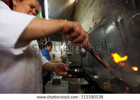 CHANG, THAILAND - JANUARY 23:  Unknown vendors prepare food at a street side restaurant on Jan 23, 2012 in Chang, Thai. Government figures indicate more 16,000 registered street vendors in Thailand.