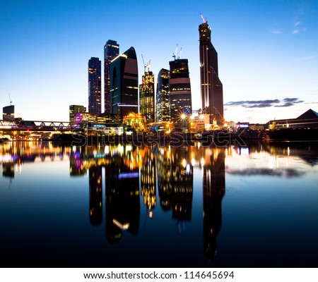 New skyscrapers Moscow business centre (Moscow City) at evening with water reflections.