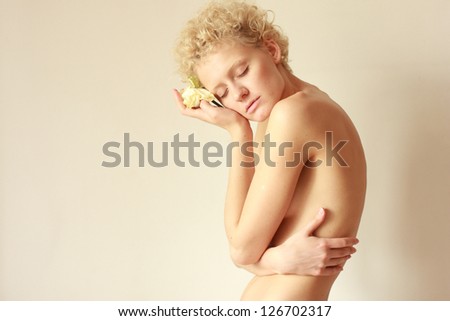 Young sexy topless girl in gentle tones (closing his arms)