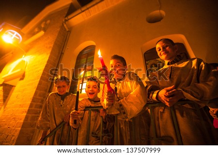 METHANA, GREECE - MAY 5: Unidentified children in the church during the celebration of Orthodox Easter, May 5, 2013 in Methana, Greece.