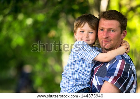 Portrait of father and son in the park