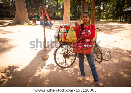 SIEM REAP, CAMBODIA - DEC 13: An unidentified cambodian street seller in Angkor Wat, Dec 13, 2012 on Siem Reap, Cambodia. Angkor is the country's prime attraction for visitors.