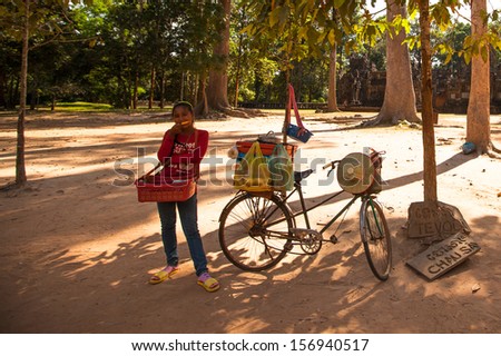 SIEM REAP, CAMBODIA - DEC 13: An unidentified cambodian street seller in Angkor Wat, Dec 13, 2012 on Siem Reap, Cambodia. Angkor is the country\'s prime attraction for visitors.