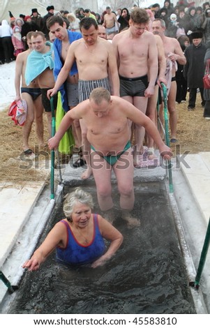TOMSK, RUSSIA - JANUARY 19: Swimming in the ice-hole, celebration of Epiphany (Holy Baptism) in the Orthodox tradition, January 19, 2010 in Tomsk, Russia.