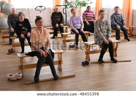 PODPOROZHYE, RUSSIA - MARCH 11: Day of Health in Center of social services for pensioners and the disabled Otrada (gymnastics with sticks for eldery), March 11, 2010 in Podporozhye, Russia.