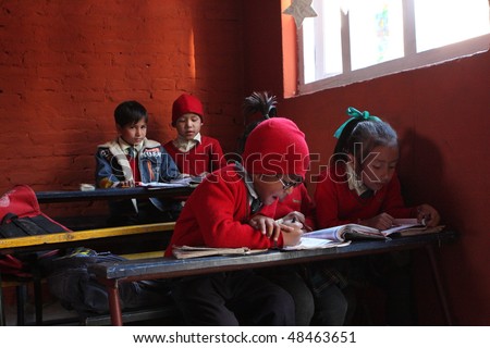 KATHMANDU, NEPAL - JANUARY 1: Pupil in learning session during lesson in small primary school 