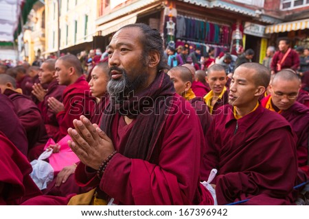 KHATMANDU, NEPAL - DEC 15: Unidentified tibetan Buddhist monks near stupa Boudhanath during festive Puja of H.H. Drubwang Padma Norbu Rinpoche\'s reincarnation\'s, Dec 15, 2013 in Khatmandu, Nepal.