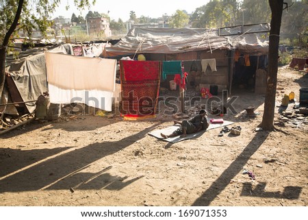 KATHMANDU, NEPAL - DEC 16: Unidentified poor people near their houses at slums in Tripureshwor district, Dec 16, 2013 in Kathmandu, Nepal. Caste of untouchables in Nepal, is about 7 % of population.