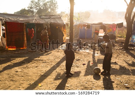 KATHMANDU, NEPAL - DEC 16: Unidentified poor people near their houses at slums in Tripureshwor district, Dec 16, 2013 in Kathmandu, Nepal. Caste of untouchables in Nepal, is about 7 % of population.