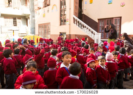 KATHMANDU, NEPAL - DEC 22: Unknown pupils during dance lesson in primary school, Dec 22, 2013 in Kathmandu, Nepal. Only only 25% of girls attend schools and half of the children can reach the 5 grade.