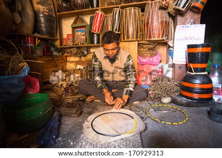 BHAKTAPUR, NEPAL - DEC 19: Unidentified master makes drums in his workshop, Dec 19, 2013 in Bhaktapur, Nepal. 100 cultural groups have created an image Bhaktapur as Capital of Nepal Arts.