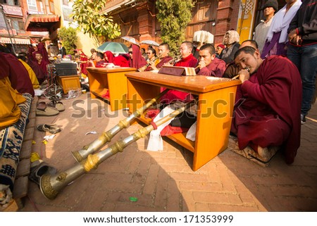 KHATMANDU, NEPAL - DEC 17: Unidentified tibetan Buddhist monks near stupa Boudhanath during festive Puja of H.H. Drubwang Padma Norbu Rinpoche\'s reincarnation\'s, Dec 17, 2013 in Khatmandu, Nepal.