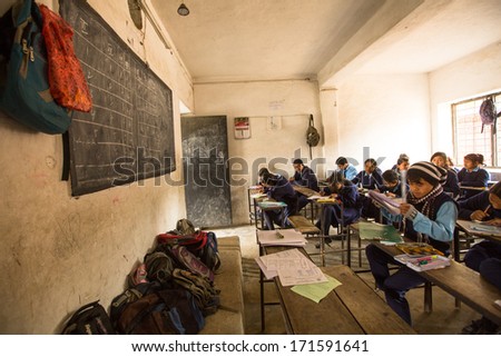 KATHMANDU, NEPAL - DEC 19: Unknown children in the lesson at public school, Dec 19, 2013 in Kathmandu, Nepal. Adult literacy (age 15+) 60.3% (female: 46.3%, male: 73%) in a 2010 population census.