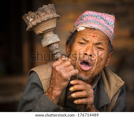BHAKTAPUR, NEPAL - DEC 7:  Portrait of unidentified Nepalese man smokes on the street, Dec 7, 2013 in Bhaktapur, Nepal. 100 cultural groups have created an image Bhaktapur as Capital of Nepal Arts.