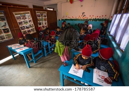 KATHMANDU, NEPAL - DEC 24, 2013: Unknown pupils in English class at primary school. Only 50% of  children in Nepal can reach 5 grade.