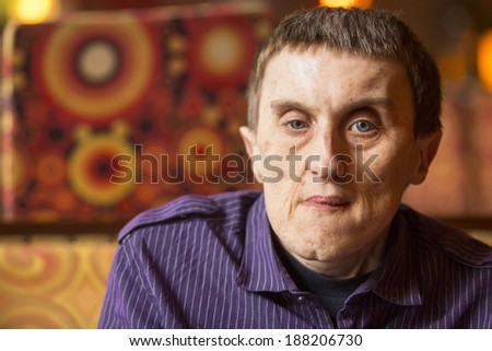 Portrait of disabled man with cerebral palsy in rehabilitation center.