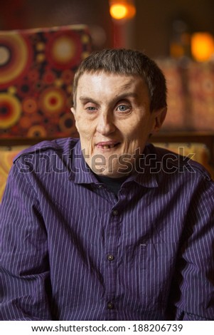 Portrait of disabled man with cerebral palsy in rehabilitation center.