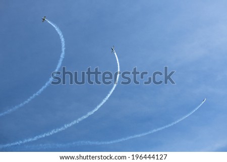 BERLIN, GERMANY - MAY 21, 2014: Aerobatic team 3x Fly Sinthesis Texan Top Class (Wefly team, Italy) demonstration during the International Aerospace Exhibition ILA Berlin Air Show-2014.