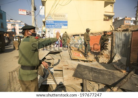 KATHMANDU, NEPAL - DEC 24, 2013: Unknown nepalese police during a operation on demolition of residential slums. In KTM is home to 50,000 squatters spread across city slums.