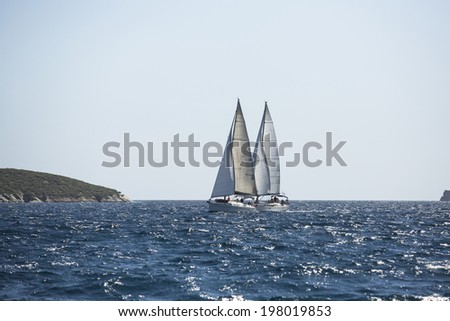 AEGEAN SEA, GREECE - APR 29, 2014: Unidentified sailboats participate in sailing regatta \