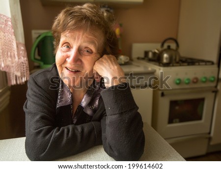Portrait of a smiling elderly woman in her house.