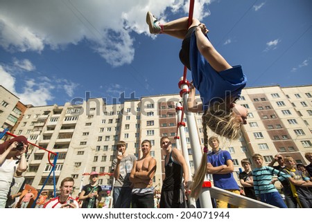 TIKHVIN, RUSSIA - JULY 7, 2014: Unidentified participants city competitions in Street workout timed to the celebration of the day of the city of Tikhvin.